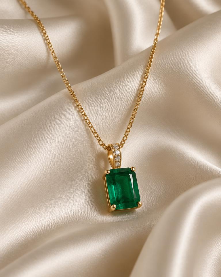 Emerald pendant on ivory silk